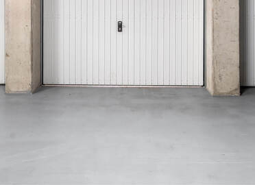 What should you use to paint a concrete floor in a garage, workshop or basement?